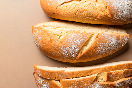 Bread slices on brown background, top view, close-up