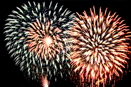 Colorful fireworks of various colors over night sky, celebration and anniversary conceptの写真素材