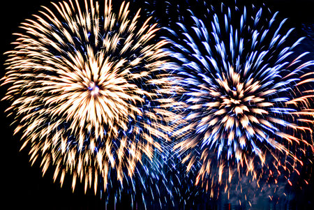 Colorful fireworks of various colors over night sky background. Abstract backgroundの写真素材