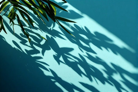 Shadow of a palm leaf on a blue wall. Nature background.