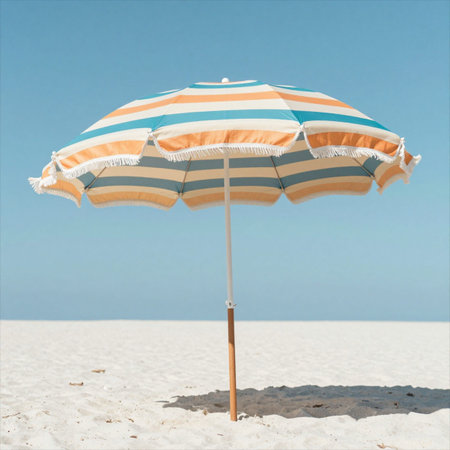 Beach umbrella on the sandy beach against blue sky. Vacation concept