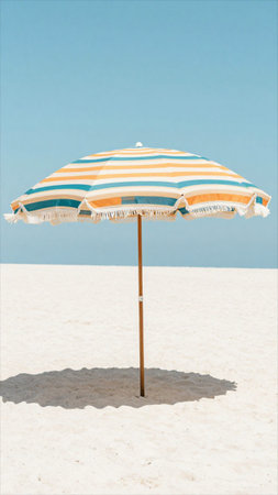 Beach umbrella on the white sand of the beach with blue sky