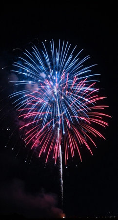 Colorful fireworks of various colors over night sky background. Selective focus.