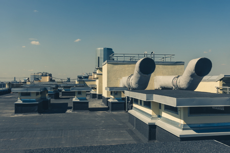 Pipes of ventilation are located on a wall of a residential buildingの写真素材