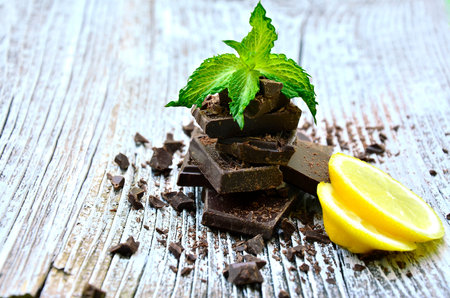 Chocolate and mint on a wooden table.Selective focus.の写真素材
