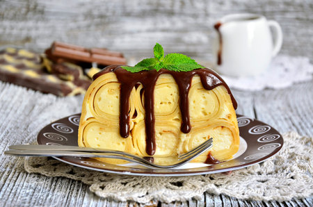 Casserole from flapjack with ricotta and chocolate sauce.