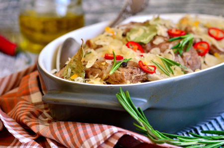 Pork ribs stewed with sour cabbage on a wooden table.の写真素材