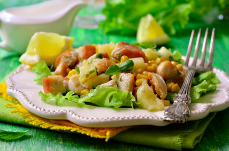 Salad with fried chicken,pineapple and sweet corn on green wooden table.の写真素材