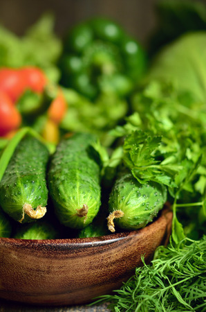 Bowl of fresh organic cucumber with green vegetables and herbs.の写真素材