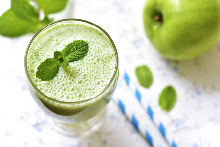 Refreshing summer apple and mint smoothie in a glass.の写真素材