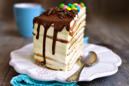 Piece of layered cale with whipped cream and mascarpone on wooden background.