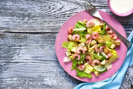 Caesar salad with shrimps on a rustic background.の写真素材