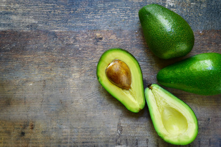 Ripe fresh organic avocado on a rustic wooden background.Top view.