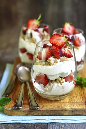 Delisious traditional english dessert eton mess with strawberry on a wooden background.の写真素材