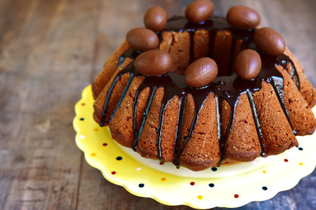 Festive chocolate cake on a rustic wooden background.