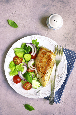 Grilled chicken fillet with vegetable salad.Top view.の写真素材
