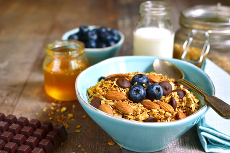 Granola with chocolate and almond - healthy breakfast concept.Rustic style.