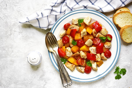 Roasted vegetables with chicken on a vintage plate.Top view.の写真素材