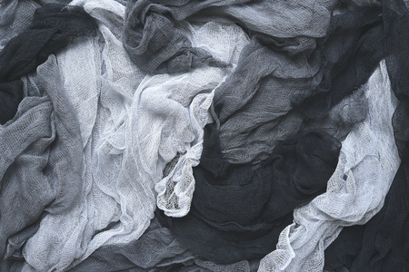 Hand dyed pastel colored gauze fabric in gray .Colorful cloth texture background.の写真素材