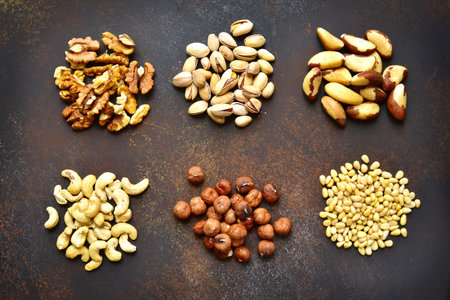 Assortment of delicious nuts on an old rusty metal background.Concept of healthy snack.
