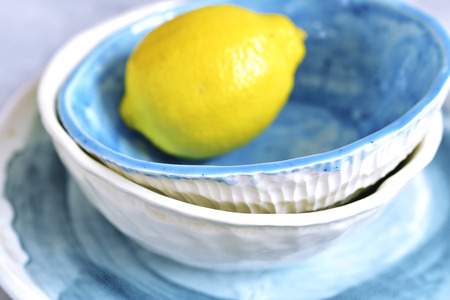 Craft glazed ceramic bowls on a light slate,concrete or stone background.の写真素材
