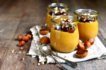 Caramel hazelnut pudding with chocolate in a vintage glass jar.の写真素材