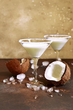Coconut martini in a glasses over dark slate background with ice cubes.の写真素材