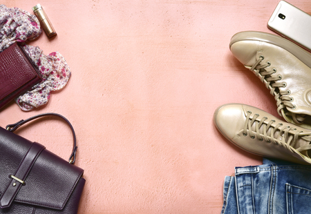 Woman clothing set - boots and  blue jeans on a pastel slate, stone or concrete background.Top view with copy space.の写真素材