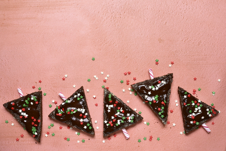Chocolate christmas tree on a rose slate, stone or concrete background.Top view with copy space.の写真素材