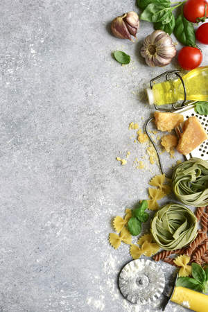 Ingredients and props for cooking of traditional italian dish on a light grey slate, stone or concrete background.Top view with copy space.の写真素材