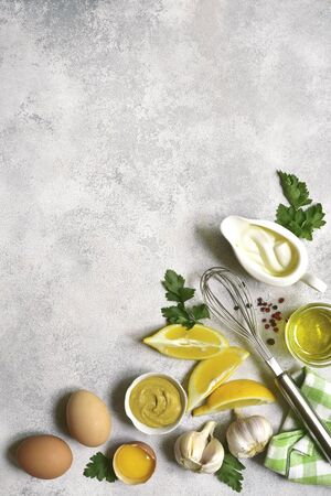 Ingredients for making mayonnaise salad dressing on a light slate, stone or concrete background. Top view with copy space.の写真素材