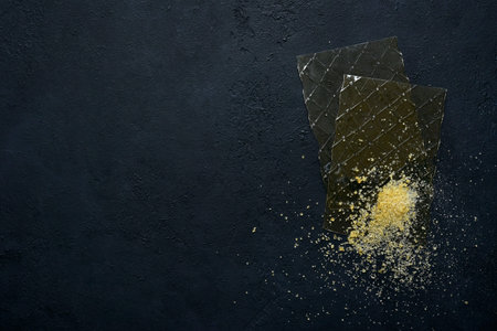 Different types of gelatine on a black slate, stone or concrete background. Top view with copy...