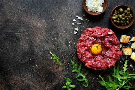 Beef tartare on a black slate or metal background- traditional dish of french cuisine.Top view.の写真素材