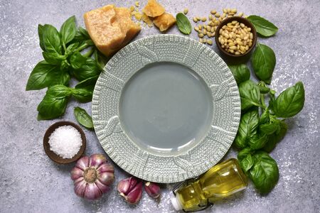 Food background with fresh ingredients for making basil pesto on a light slate, stone or concrete background. Top view with copy space.の写真素材