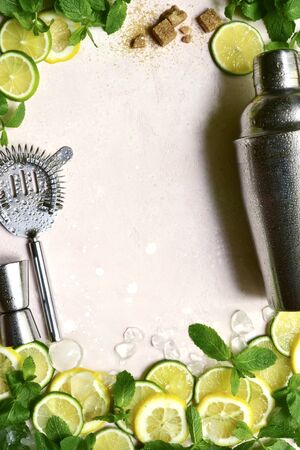 Background with ingredients and props for making summer citrus cocktail on a pink slate, stone or concrete backdrop. Top view with copy space.の写真素材