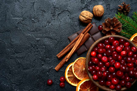 Christmas culinary background with winter spices and ingredients for baking on a black slate, stone or concrete background. Top view with copy space.の写真素材