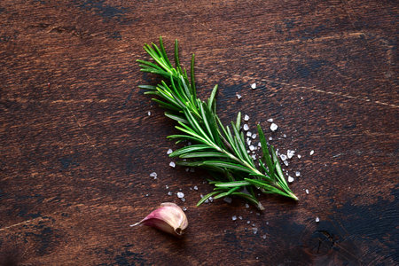 Cooking background with spices on a dark wooden table. Top view with copy space.