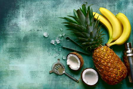 Ingredients for making delicious tropical cocktail pina colada: pineapple, coconut, banana on a...