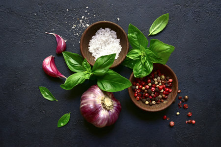 Culinary background with traditional italian spices: basil, garlic, sea salt, pepper and olive oil...
