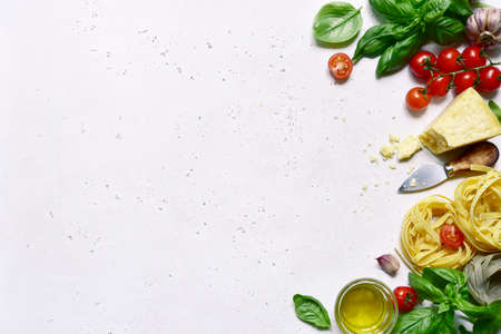 Culinary background with traditional ingredients of italian cuisine on a white slate, stone or concrete table. Top view with copy space.の写真素材