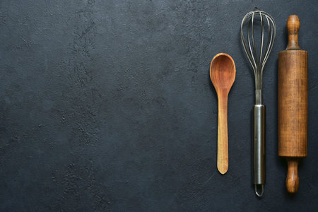Cooking background with ingredients and props for baking on a blsck slate, stone or concrete table. Top view with copy space.の写真素材