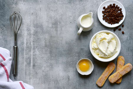 Ingredients for making traditional italian dessert 'Tiramisu "on a light gray slate, stone or concrete backgroundの写真素材