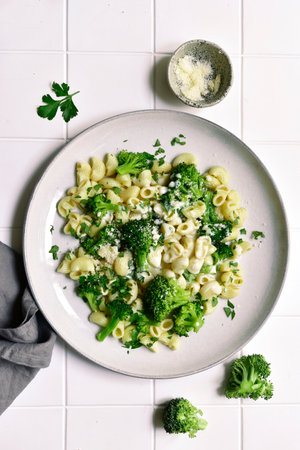 Pasta with broccoli and cream sauce on a white background. Top view with copy space.の写真素材