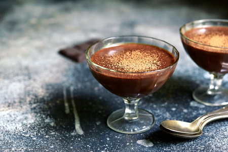 Chocolate mousse with nuts in a glasses on a slate, stone or concrete table.の写真素材