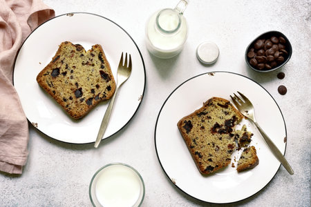 Homemade delicious cake with chocolate drops on a plates over white slate, stone or concrete background. Top view with copy space.の写真素材