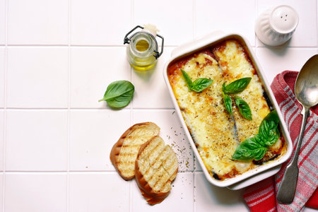 Italian eggplant dish melanzane alla parmigiana on a white background.Top view with copy space.の写真素材