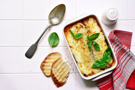 Italian eggplant dish melanzane alla parmigiana on a white background.Top view with copy space.の写真素材