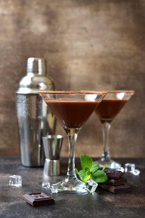 Delicious chocolate coffee martini with mint in a glasses on a dark slate, stone or concrete background.の写真素材