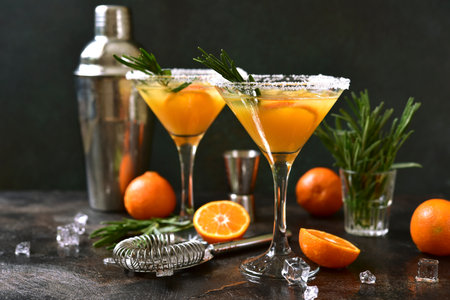 Tangerine cocktail with rosemary on a dark slate, stone or concrete background.の写真素材
