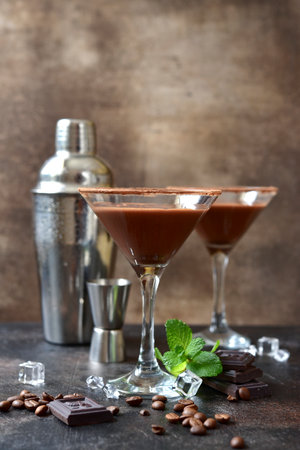 Delicious chocolate coffee martini with mint in a glasses on a dark slate, stone or concrete background.の写真素材